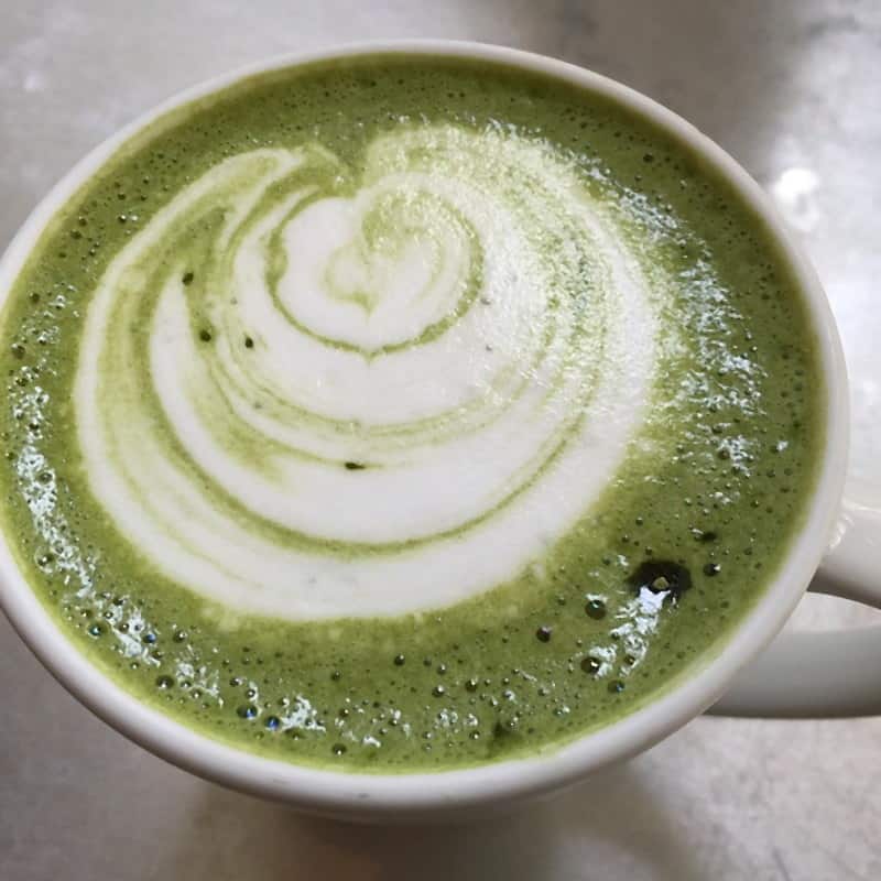 A matcha latte swirled into a spiral, seen from above