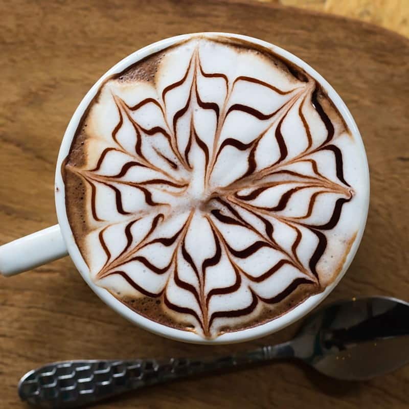 A mocha finished with a chocolate pattern etched across the foam