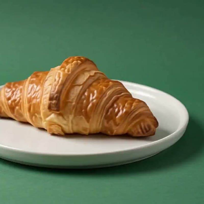 Twice-baked almond croissant on a white plate