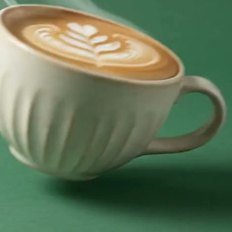 Cup of batch-brewed filter coffee on a green surface