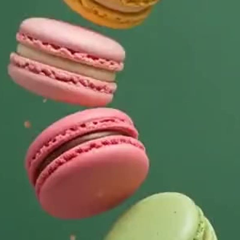 Pink rose macaron with a smooth shell and visible foot