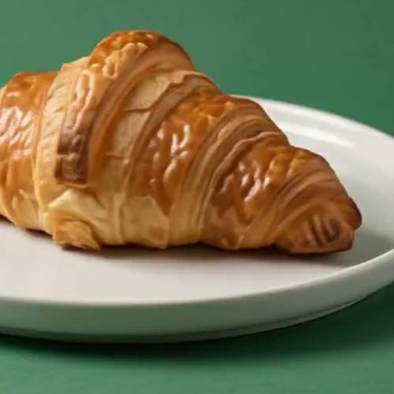 Cardamom and orange morning bun on a white plate